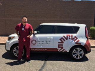 Phlebotomist in front of Sonora Quest vehicle